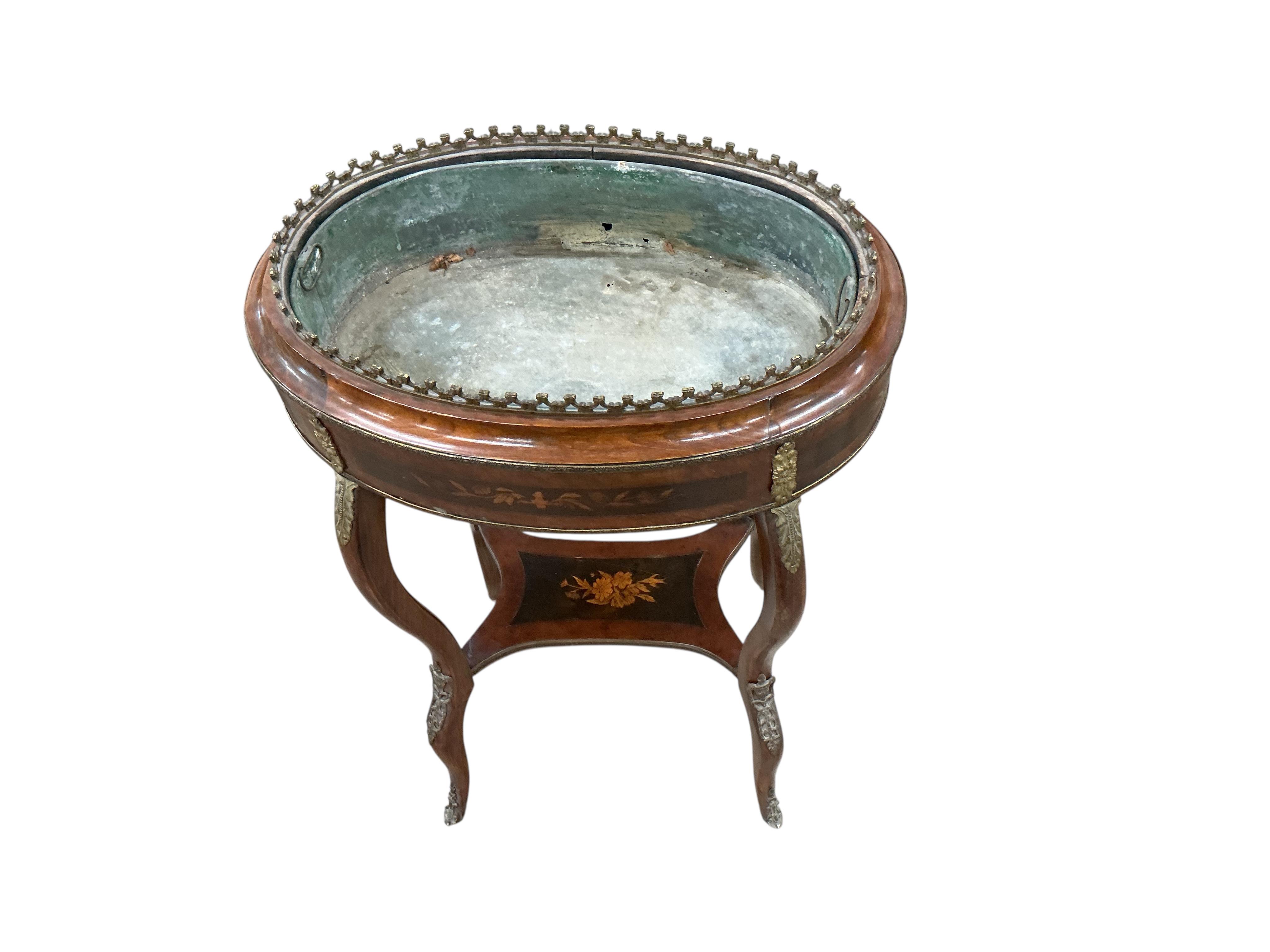 A French Louis XVI style oval gilt metal mounted marquetry inlaid walnut and beech jardiniere table, width 56cm, depth 38cm, height 80cm